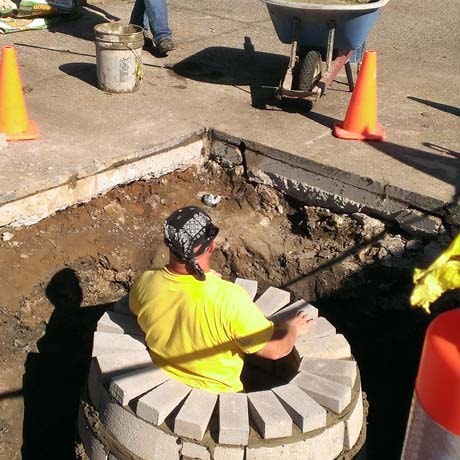 Central Seal coat's employees patching a commercial parking lot